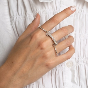Silver multi-layer stainless steel double ring with white pearls on a model