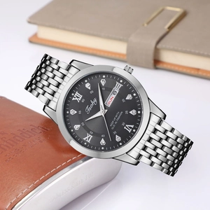 Detail of silver stainless steel watch with black sunray dial and day-date display
