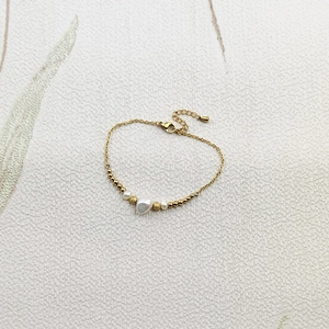 Detail of gold chain bracelet with freshwater pearls and a secure lobster clasp closure