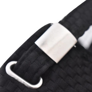Detailed macro shot of the black woven checkered fabric and silver adjustable metal buckle