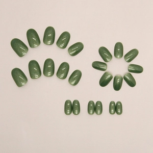 Sparkling forest green oval press-on nails with 24 pieces featuring cat-eye glitter finish