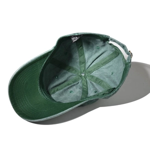 Dark green cotton baseball cap showing internal stitching and adjustable metal buckle