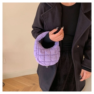 Close-up of a purple quilted puffy cloud bag featuring a trendy ruched texture and zipper