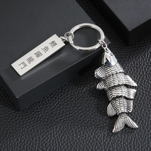 Macro detail of the stainless steel koi fish keychain with engraved Chinese characters