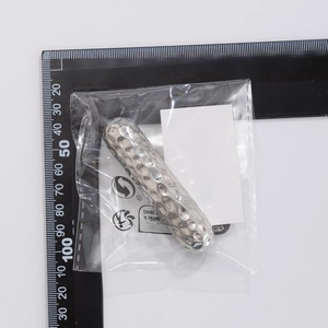 Detail of silver hammered metal hairpiece showing 7cm length with scale measurement