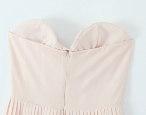 Close-up of pink pleated dress featuring a back invisible zipper and bustier design