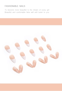 Close-up of nude pink press-on nails featuring white daisy patterns and French tips