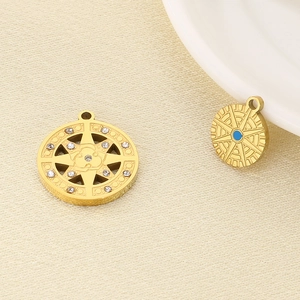 Close-up of gold North Star charms with rhinestones and blue enamel details