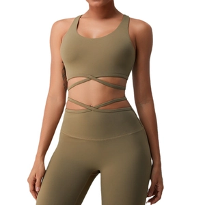 Olive green yoga set featuring cross-strap sports bra and high-waisted leggings