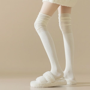 Classic white over-knee ribbed socks with trendy slouchy texture and soft cream finish