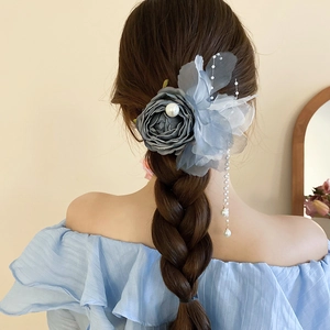 Lace rose hair clip with dangling pearls shown on elegant braided hairstyle back view