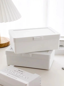 White stackable storage boxes with lids for organizing stationery and cosmetics