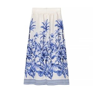 Women's blue and white floral printed long skirt with tropical palm tree motifs and stripes