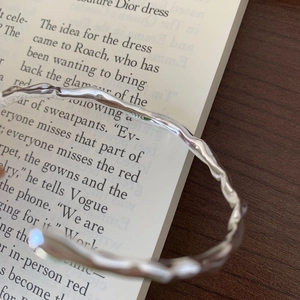 Detail view of wavy texture and S925 hallmark on the silver open cuff bracelet