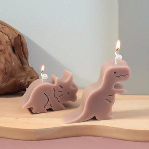 Macro-detail van dinosaurusvormige kaarsen in oudroze met matte oppervlaktestructuur