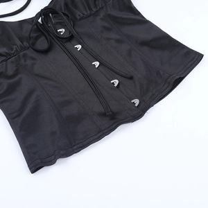 Detailed macro view of black satin corset with silver metal hooks and lace-up straps