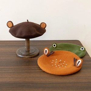 Detailed view of handmade wool felt berets featuring cute bear and reindeer ear designs