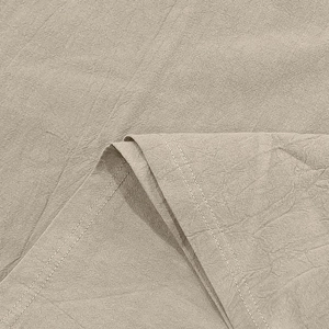 Close-up of beige linen polo shirt fabric showing textured weave and neat stitching detail