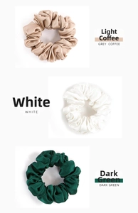 Detailed texture of 100% silk scrunchies in coffee, white, and dark green tones