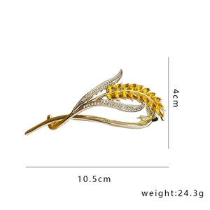 Detailed view of crystal wheat ear hair clip in gold with size and weight dimensions