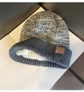 Detail view of thick faux fleece lining inside the grey melange knitted winter beanie