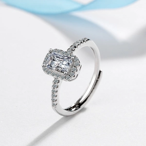 Silver square cut cubic zirconia ring with micro-pave setting on white texture background