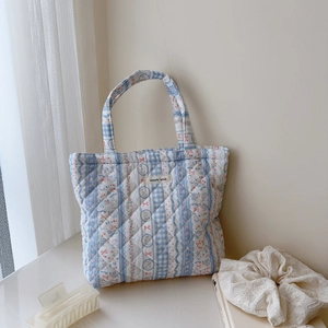 Quilted cotton floral tote bag in light blue with bow pattern and simple wish label