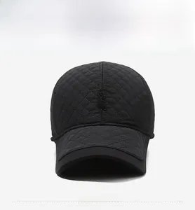 Detailed front view of black quilted winter baseball cap with diamond pattern and SPORT tag