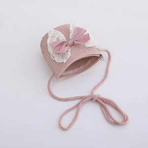Detailed view of pink straw crossbody bag with mesh lace and satin ribbon bow decoration