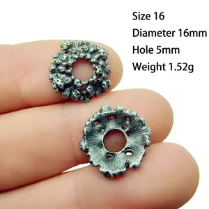 Detailed macro view of 16mm antique silver alloy flower spacers for DIY jewelry making
