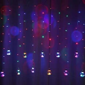 Colorful LED curtain string lights with clear wish ball ornaments for festive home decoration