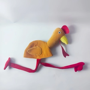 Detail view of plush turkey hat with long red legs and yellow body for festive parties