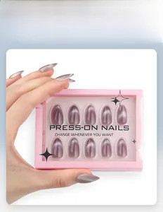 Detail of grey almond press-on nails with cat eye magnetic effect in a pink gift box