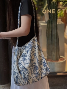 Detailed shot of large capacity canvas tote bag with blue botanical floral patterns