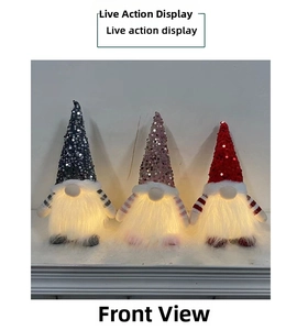 Three glowing Christmas gnomes with sequin hats and warm LED lights on a white display
