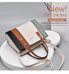 Detail view of multi-color leather handbag with stitching details on display stand