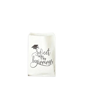 Detail of white graduation paper gift bag with black mortarboard and sweet slogan