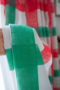 Detail of red and green plaid linen blend curtain fabric showing high-quality texture