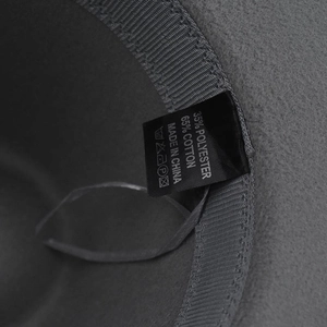 Detail of grey fedora interior showing fabric label with 65% cotton and 35% polyester mix