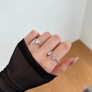 Close-up of S925 silver rings with heart-cut pink and clear cubic zirconia stones