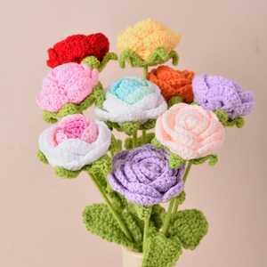 Handmade knitted yarn rose bouquet featuring various vibrant colors on pink background