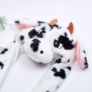 Detailed shot of soft plush cow hat featuring realistic brown horns and pink inner ears
