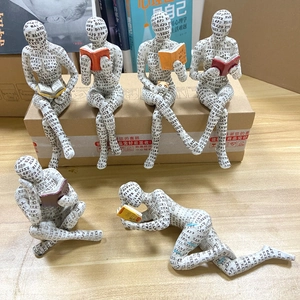 Set of six reading woman resin figurines with artistic typography print on surface