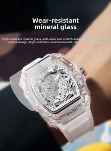 Detail of tonneau-shaped skeleton mechanical watch with transparent case and white silicone strap