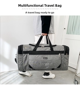 Detail view of large dark grey nylon travel bag with reinforced handles and SPORT logo