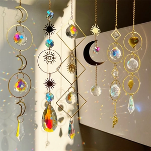 Golden sun and moon crystal prisms casting rainbow light reflections on the wall