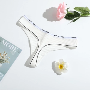 Detailed macro view of white ribbed cotton thong with LOVE YOU printed waistband