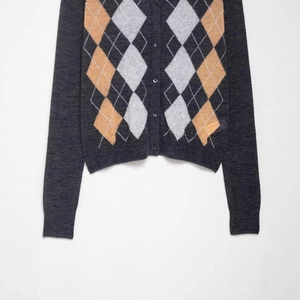 Women's dark grey argyle knit cardigan with orange diamond pattern and button closure