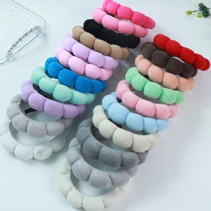Set of colorful velvet sponge headbands in various bright colors on a white background