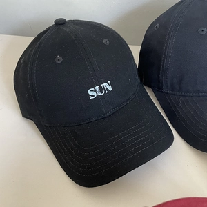 Detail of sun letter embroidery and premium cotton twill fabric on black baseball caps